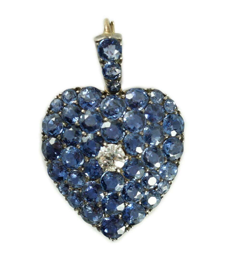 A late 19th/early 20th century gold and silver, sapphire and diamond heart shaped cluster pendant